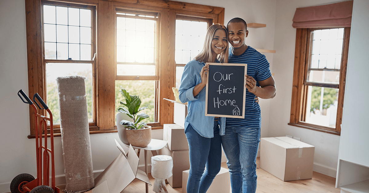 Happy couple showing sign of first home