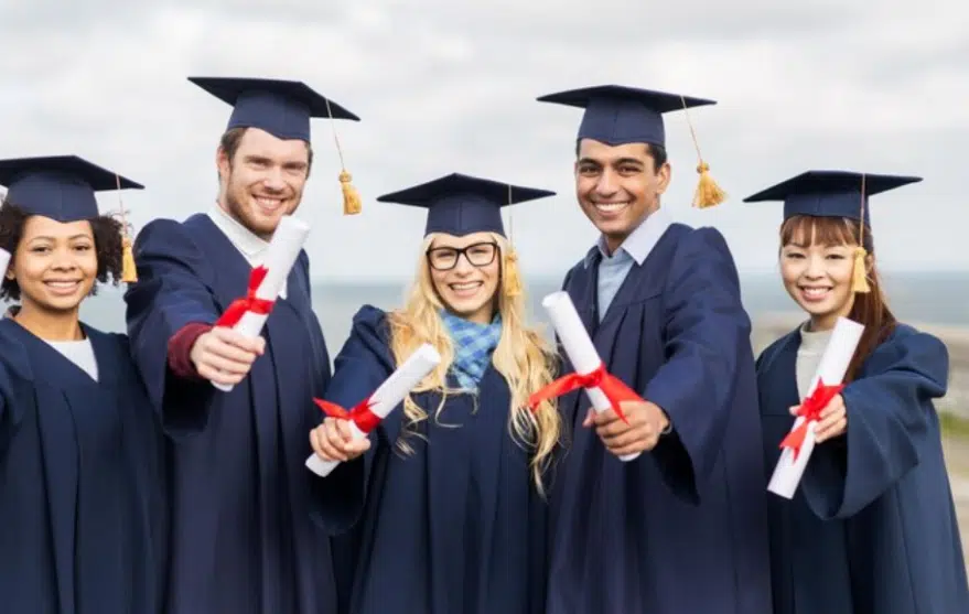 International students showing degrees after completion and smiles