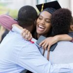 Students happily hug each other