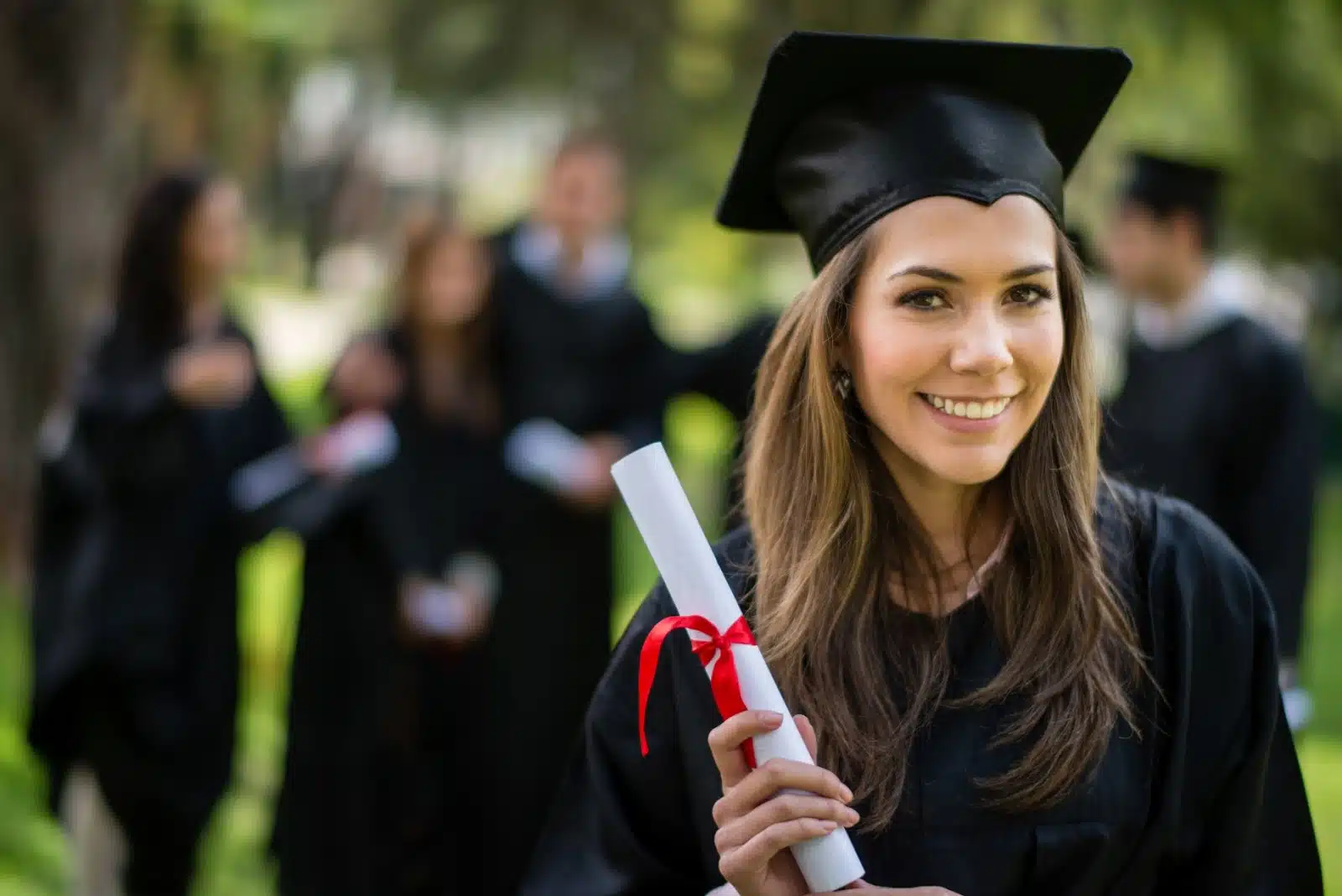 female student give pose with degree