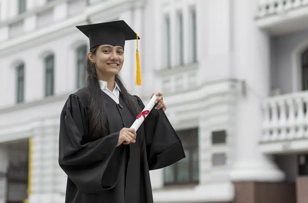 girl smiling and holding scholarship